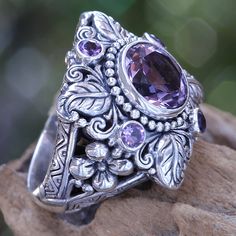 Faceted and polished amethyst crowns this elegant ring. Kadek Hendra works in sterling silver and amethysts totaling 3.4 carats. The handcrafted design reveals its Balinese origin with luscious flower and plant motifs. .925 Sterling silver Amethyst Flower, Bohemian Rings, Purple Crystals, Crystal Flower, Amethyst Stone, Flower Ring, Crystal Rings, Amethyst Ring, Ring Vintage