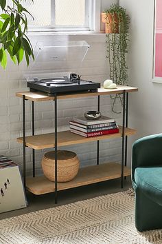 a living room with a couch and a record player on top of a wooden shelf