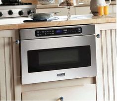 a stainless steel oven in a white kitchen