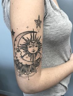 a woman with a sun and moon tattoo on her arm