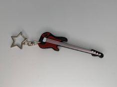 a keychain with a guitar shaped like a star hanging from it's side