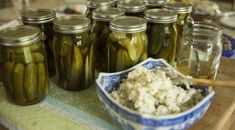 jars filled with pickles sitting on top of a table