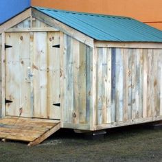 a small wooden shed sitting in front of a building