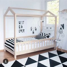 a white bed with black and white decor in a room