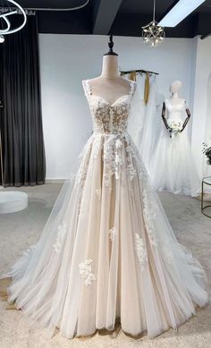 a wedding dress on display at a bridal shop in the middle of a room