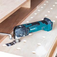 a cordless drill is laying on top of a drawer with screwdriver in it