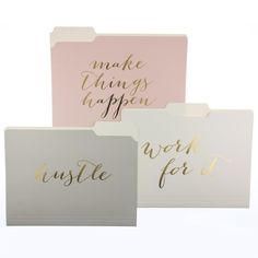 three different colored folders with gold foil lettering on the front and back of them