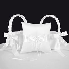 a white ring pillow with a bow on it