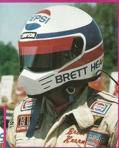 a man wearing a racing helmet with the words breit head on it's side