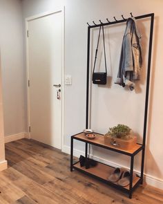 an entryway with a coat rack and shoes