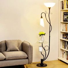 a living room with a couch, lamp and bookshelf