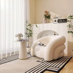 a modern living room with white furniture and plants in vases on the side table