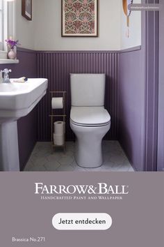 a bathroom with purple walls and white fixtures