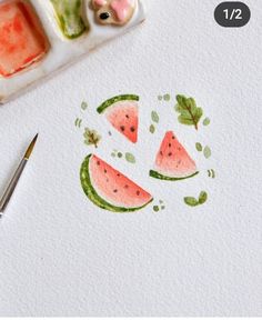 watermelon slices drawn on white paper next to paintbrushes