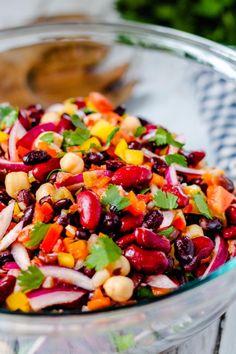 a colorful salad in a glass bowl on a table