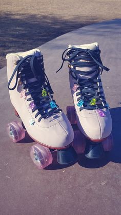 a pair of roller skates sitting on top of a sidewalk