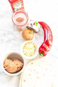 ingredients to make an enchilada recipe laid out on a marble counter top