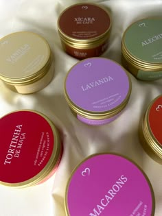 six different types of lip bales sitting on a white sheet with the names lavanda and macarons