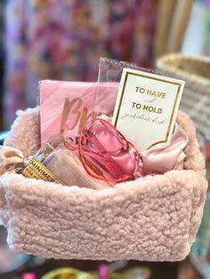 a pink hat with some items inside of it and a card that says to have to hold