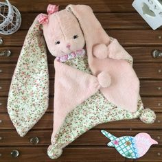 a stuffed animal laying on top of a wooden floor