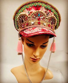 This is a stunning one off hand crafted captain hat. It has a pink rose detail. A feast fir the eyes! It is enriched with gems, beads ,jewels ,trim and feather. It has chains and tassels detail. This is stunning hat . It is a size 59 Cm which fits most heads . Any trace of glue or creases are not defects but characteristics of a hand crafted hat and markings are deliberate to create a rustic antique look. Thank you for looking Traditional Carnival Costume Hats And Headpieces For Party, Adjustable Crown Costume Hat For Festivals, Bohemian Costume Hat With Structured Crown For Festivals, Adjustable Festival Headpiece With Rhinestones, Adjustable Festival Hat With Structured Crown, Adjustable Hat With Structured Crown For Festivals, Adjustable Rhinestone Festival Headpiece, Adjustable Rhinestone Headpiece For Festival, Adjustable Structured Crown Hat For Festival