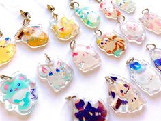 a bunch of glass charms sitting on top of a white table next to each other