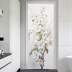 a white bathroom with black and white checkered flooring is decorated with an orchid painting