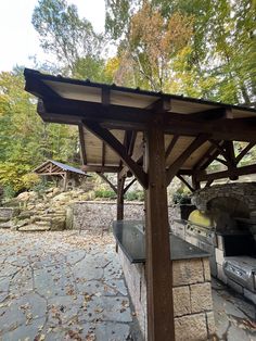 an outdoor grill area in the middle of a wooded area