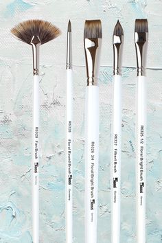 five brushes are lined up in a row on a blue and white background with words written below them