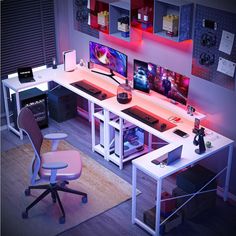 a computer desk topped with two monitors and a keyboard next to a chair in front of it