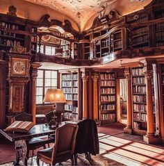 an old library with many bookshelves and chandeliers on the ceiling is shown