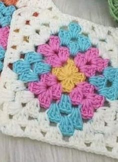 two crocheted squares with flowers on them