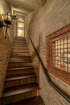 a set of stairs leading up to a window in an old brick building with stained glass windows