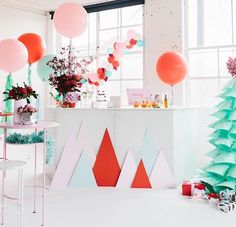 a party with balloons and decorations in the shape of mountains