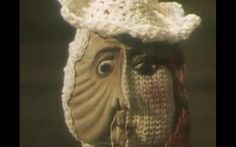 a close up of a person wearing a crocheted hat