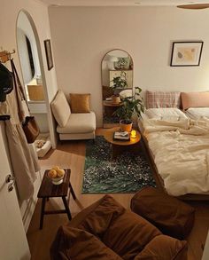 a bed room with a neatly made bed and a mirror on the wall above it