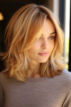 Honey blonde tendrils bring warmth to your face and work beautifully with any skin tone. The loose waves can be created with a curling iron or natural texture. Click here to check out more cute and fun shoulder-length haircuts and hairstyles. Shoulder Lenght Haircut Girl, Top Of Shoulder Haircut, Hair Cut 2024 Girl Medium, Short Hair Styles For Long Face Shape, Shoulder Length Hair Long Bangs, Shoulder Length Hair With Curls, Women’s Hair Cuts Medium, Front Layers Medium Hair Face Framing Shoulder Length, Face Framing Layers Shoulder Length Hair