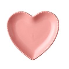 a pink heart shaped plate on a white background