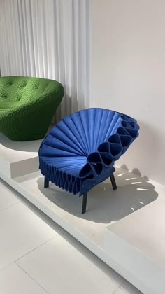 two blue chairs sitting on top of a white shelf