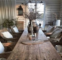 a wooden table topped with vases sitting on top of a wooden dining room table