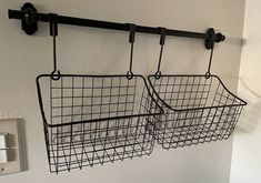 two metal baskets hanging on the wall