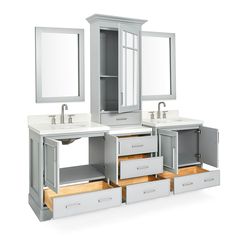 a bathroom vanity with two sinks and mirrors