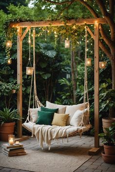 a porch swing with lights hanging from the ceiling and pillows on it's sides