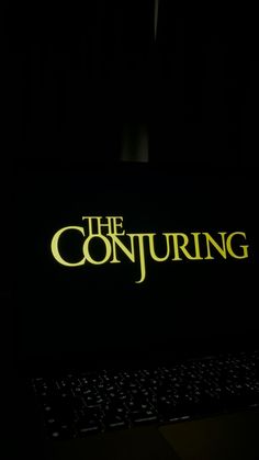 the conjuring logo lit up on a computer keyboard