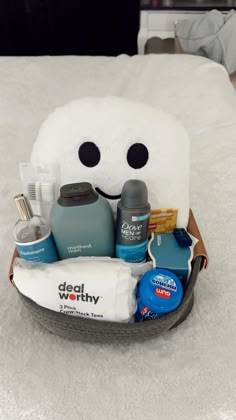 a white bed topped with a basket filled with personal care items and toothbrushes