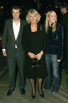 two women and a man standing next to each other