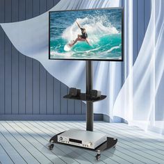 a flat screen tv sitting on top of a metal stand