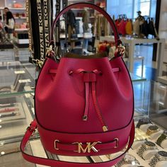 Michael Kors Reed Medium Pebbled Leather Bucket Bag Satchel Crossbody Handbag Electric Pink Nwt New With The Tag Authentic The Reed Infuses Glamor Into An Otherwise Austere Bucket Bag Design. Crafted From Smooth Leather, It Features A Drawstring Closure That Opens To A Spacious Interior. A Belted Feature With Our Gold-Tone “Mk” Hardware And Coordinating Accents Finish It With A Gilded Touch. Carry It By The Top Handle Or Wear It Crossbody With The Removable Strap. Bucket Bag Pebbled Leather 100% Designer Pink Bucket Bag For Travel, Luxury Pink Bucket Bag For Everyday, Luxury Pink Bucket Bag For Travel, Elegant Pink Bucket Bag For Travel, Pink Satchel Bucket Bag With Detachable Strap, Pink Bucket Bag With Detachable Strap Satchel, Michael Kors Bucket Bag With Removable Pouch For Shopping, Luxury Michael Kors Bucket Bag For Travel, Pink Bags With Branded Hardware For Everyday Use