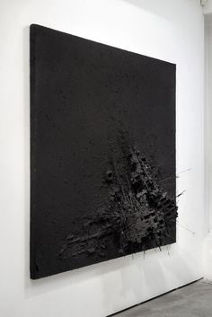 a black and white painting hanging on the wall