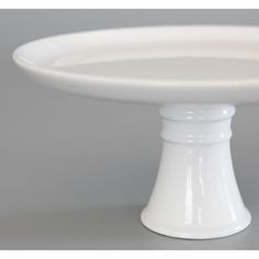 a white cake plate sitting on top of a table